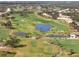 Scenic golf course aerial featuring a lush green landscape with ponds and well-placed sand traps at 905 Barclay Ct, Venice, FL 34293