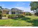 Expansive backyard featuring a lush green lawn and screened-in lanais for outdoor enjoyment at 905 Barclay Ct, Venice, FL 34293