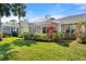 Well-manicured backyard with a screened-in lanai and beautiful tropical plants at 905 Barclay Ct, Venice, FL 34293