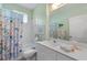 This soothing bathroom offers a tub/shower combo, bright lighting, and a floral shower curtain at 905 Barclay Ct, Venice, FL 34293