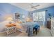 This bedroom offers a serene retreat with light blue walls, natural light, and a comfortable bed at 905 Barclay Ct, Venice, FL 34293