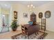 Classic dining room featuring a dark wood table, elegant chandelier, and stylish decor at 905 Barclay Ct, Venice, FL 34293