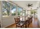 Bright dining area with views of the landscaped outdoor space and a ceiling fan at 905 Barclay Ct, Venice, FL 34293