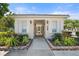 Inviting entrance to the community clubhouse with manicured landscaping and a covered walkway at 905 Barclay Ct, Venice, FL 34293