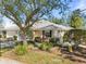 Charming single-story home featuring a well-manicured lawn and mature landscaping at 905 Barclay Ct, Venice, FL 34293