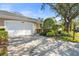 Charming home features a two-car garage, well maintained lawn, and mature landscaping at 905 Barclay Ct, Venice, FL 34293