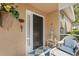 Charming front porch entrance with blue and white checkered rug and decorative accents at 905 Barclay Ct, Venice, FL 34293