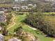 A scenic golf course with rolling green fairways winding through lush trees and sand traps at 905 Barclay Ct, Venice, FL 34293