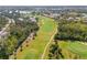 Lush golf course with pristine green fairways winding through trees and around community homes at 905 Barclay Ct, Venice, FL 34293