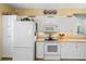 White kitchen featuring modern appliances and cabinet space at 905 Barclay Ct, Venice, FL 34293