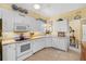 Bright kitchen featuring modern appliances, ample counter space, and neutral tile flooring at 905 Barclay Ct, Venice, FL 34293