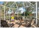 Relaxing screened lanai with comfortable seating and scenic outdoor views at 905 Barclay Ct, Venice, FL 34293