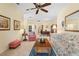 Spacious living room featuring tile floors, ceiling fan, and classic furnishings at 905 Barclay Ct, Venice, FL 34293