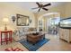 Charming living room with tile floors, ceiling fan, and seamless flow to other living areas at 905 Barclay Ct, Venice, FL 34293