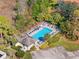 Aerial view of a community pool and cabana with lounge seating and lush landscaping at 905 Barclay Ct, Venice, FL 34293