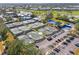 Aerial view of the tennis and pickleball courts with lush landscaping in a vibrant community at 905 Barclay Ct, Venice, FL 34293