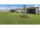 Spacious backyard with lush green grass and stunning water view with mature tree in mulch bed at 10470 Spring Tide Way, Parrish, FL 34219