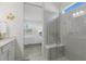 Modern bathroom featuring glass shower, white cabinets, and stylish fish decor at 10470 Spring Tide Way, Parrish, FL 34219