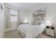 Bright bedroom features window with white shutters, art, and nightstand at 10470 Spring Tide Way, Parrish, FL 34219