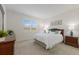 Bright bedroom with a comfortable bed, matching nightstands, and a large window with natural light at 10470 Spring Tide Way, Parrish, FL 34219