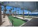 Covered bocce ball court featuring lush landscaping and shade for comfortable outdoor recreation at 10470 Spring Tide Way, Parrish, FL 34219