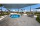 A shaded community hot tub is surrounded by lounge chairs and tables with views of the lake at 10470 Spring Tide Way, Parrish, FL 34219
