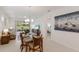 Open-concept dining area features a table set for four and access to the outdoor patio at 10470 Spring Tide Way, Parrish, FL 34219