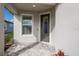 Inviting front porch with stylish door and well-maintained stone pavers at 10470 Spring Tide Way, Parrish, FL 34219