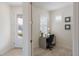 A home office with a gray desk, shuttered windows, and a view of the front door at 10470 Spring Tide Way, Parrish, FL 34219