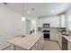 Spacious kitchen featuring white cabinets, a center island, and stainless steel appliances at 10470 Spring Tide Way, Parrish, FL 34219