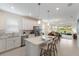 Modern kitchen with white cabinetry, stainless steel appliances, and a spacious island with bar seating at 10470 Spring Tide Way, Parrish, FL 34219