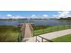 Beautiful lake view with a dock and fountain provides a relaxing vista for the residents to enjoy at 10470 Spring Tide Way, Parrish, FL 34219