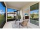 Relaxing screened lanai featuring comfortable seating and view to living area inside at 10470 Spring Tide Way, Parrish, FL 34219