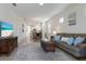 Inviting living room with a comfortable sofa and a view into the dining and kitchen areas at 10470 Spring Tide Way, Parrish, FL 34219