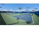 Multiple outdoor pickleball courts featuring blue and green playing surfaces in a recreational area at 10470 Spring Tide Way, Parrish, FL 34219
