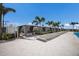 Relaxing poolside cabanas offer shade and comfort, with nearby lounge chairs and well-maintained landscaping at 10470 Spring Tide Way, Parrish, FL 34219