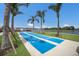 A shuffleboard court near the community lake under palm trees is ready for some fun competition at 10470 Spring Tide Way, Parrish, FL 34219