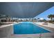 Spacious outdoor swimming pool with a splash fountain, shaded area, and lounge chairs for relaxation at 10470 Spring Tide Way, Parrish, FL 34219