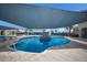 Outdoor swimming pool with a splash fountain, shaded area, and lounge chairs for relaxation at 10470 Spring Tide Way, Parrish, FL 34219