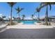 Stunning swimming pool surrounded by lush palm trees and a spacious deck area for relaxation at 10470 Spring Tide Way, Parrish, FL 34219