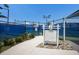 A pathway leading to a well-maintained tennis court, surrounded by lush landscaping and fencing at 10470 Spring Tide Way, Parrish, FL 34219
