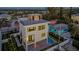 Stunning aerial view of modern home featuring a rooftop deck and private pool at 1210 Gulf Blvd, Englewood, FL 34223