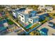 Aerial view of modern home with rooftop deck, pool, and well-manicured landscaping at 1210 Gulf Blvd, Englewood, FL 34223