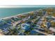Breathtaking aerial view of beachfront home with rooftop deck and lush landscaping at 1210 Gulf Blvd, Englewood, FL 34223