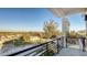 Balcony view overlooking lush greenery, houses, and clear blue sky at 1210 Gulf Blvd, Englewood, FL 34223