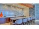 Stylish bar area with a marble backsplash, seating, and modern finishes, ideal for entertaining guests at 1211 Gulf Of Mexico Dr # 701, Longboat Key, FL 34228