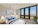 Cozy bedroom with large windows offering scenic views, complemented by a calming decor at 1211 Gulf Of Mexico Dr # 701, Longboat Key, FL 34228