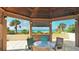 Charming gazebo with seating and scenic ocean views featuring palm trees and white sand at 1211 Gulf Of Mexico Dr # 701, Longboat Key, FL 34228