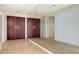 Hallway featuring a large mirror, beige tile floors, and closet storage at 1211 Gulf Of Mexico Dr # 701, Longboat Key, FL 34228