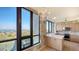 Kitchen features expansive windows, wooden cabinets, and tile countertops at 1211 Gulf Of Mexico Dr # 701, Longboat Key, FL 34228